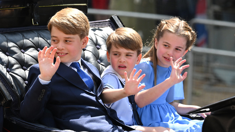 Princes George and Louis and Princess Charlotte waving