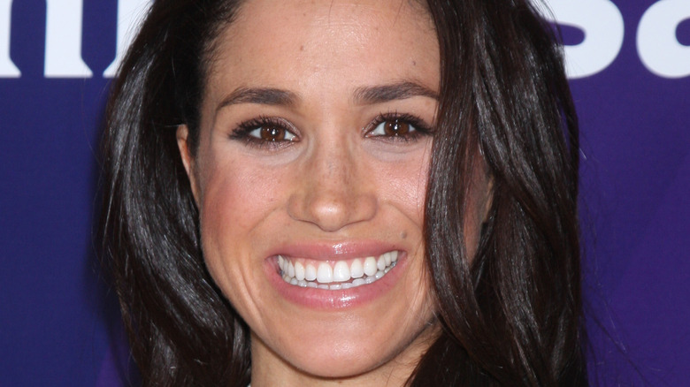 Meghan Markle smiling at press event