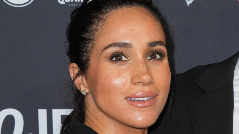 Closeup of Meghan Markle on step-and-repeat