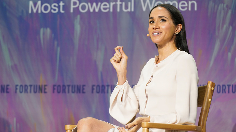 Meghan Markle, Duchess of Sussex on-stage in a chair