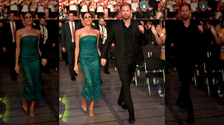 Meghan Markle and Prince Harry holding hands while walking through the audience at an event