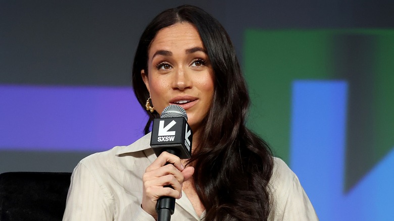 Meghan Markle talking into microphone