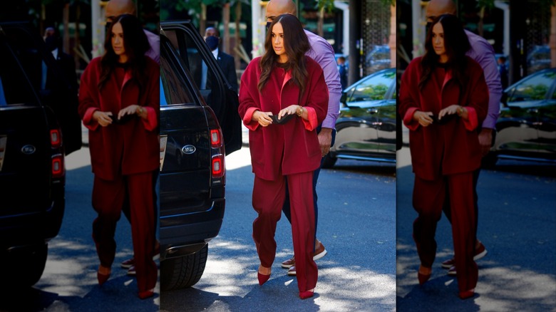 Meghan Markle walking in deep red matching outfit