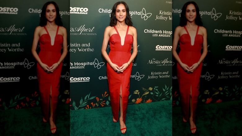 Meghan Markle poses in red dress at charity event