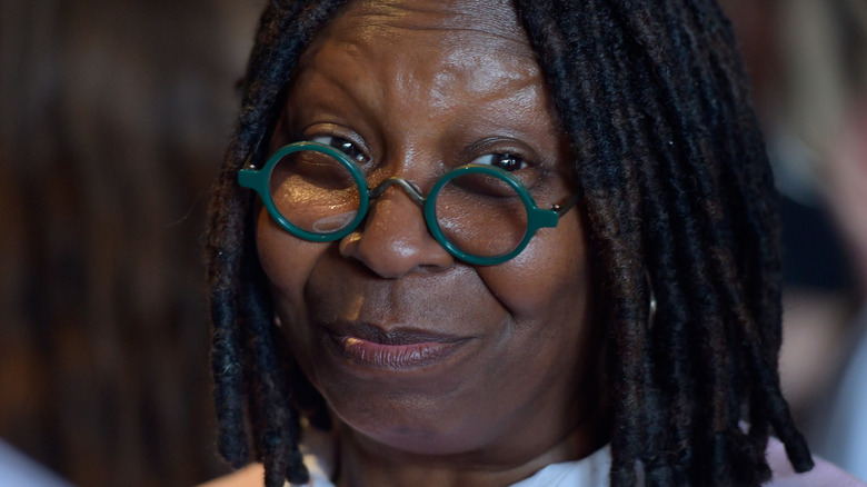 Whoopi Goldberg smiling and wearing glasses