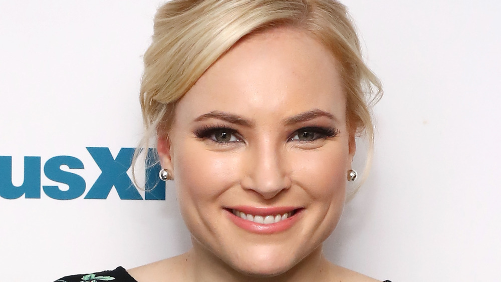 Meghan McCain smiling with silver earrings