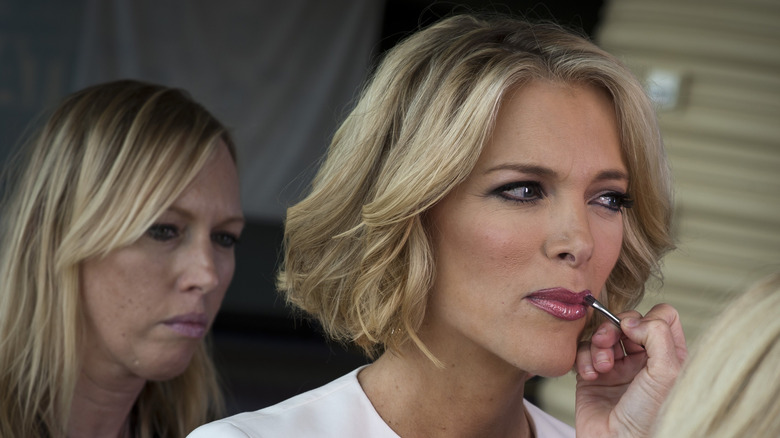 Megyn Kelly at the 2011 GOP debate while an assistant applies lipstick