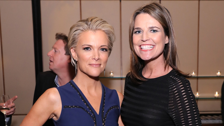 Megyn Kelly wearing blue, Savannah Guthrie wearing black, both smiling