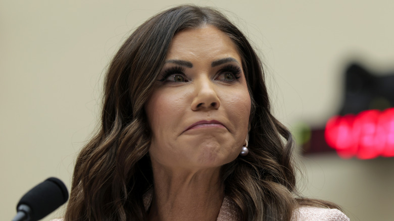 Kristi Noem frowning with microphone