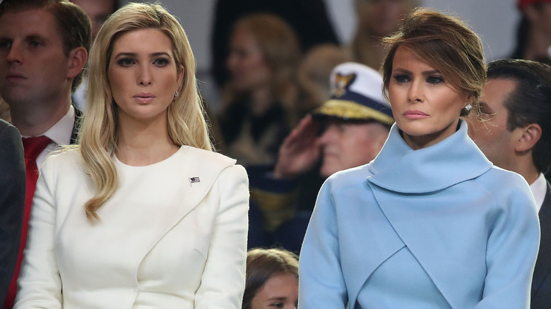 Melania and Ivanka Trump both looking serious as they're standing next to each other