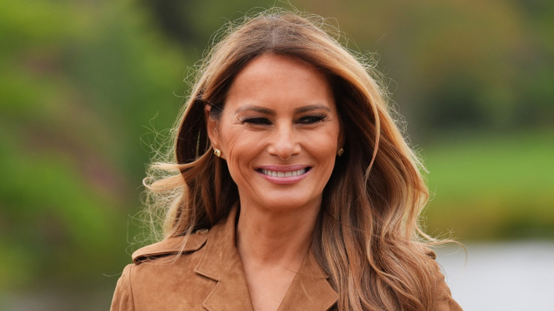 Melania Trump smiling and looking off to the side