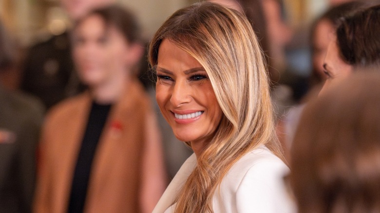 Melania Trump smiles while speaking at an event in the East Room of the White House (2025)