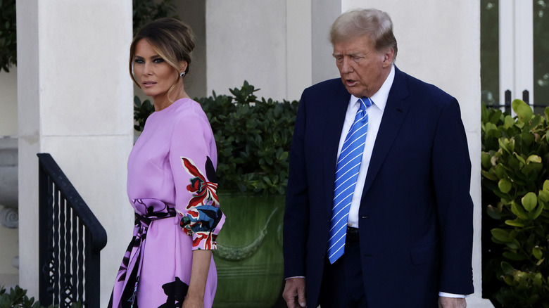 Melania Trump waking in front of Donald Trump