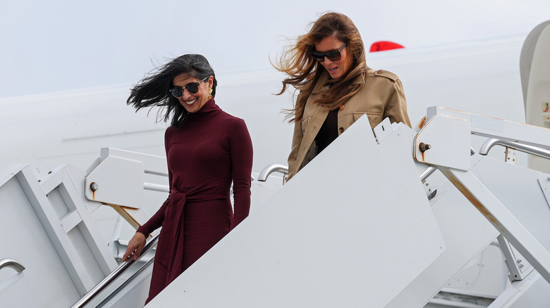 Usha Vance and Melania Trump deboard an airplane