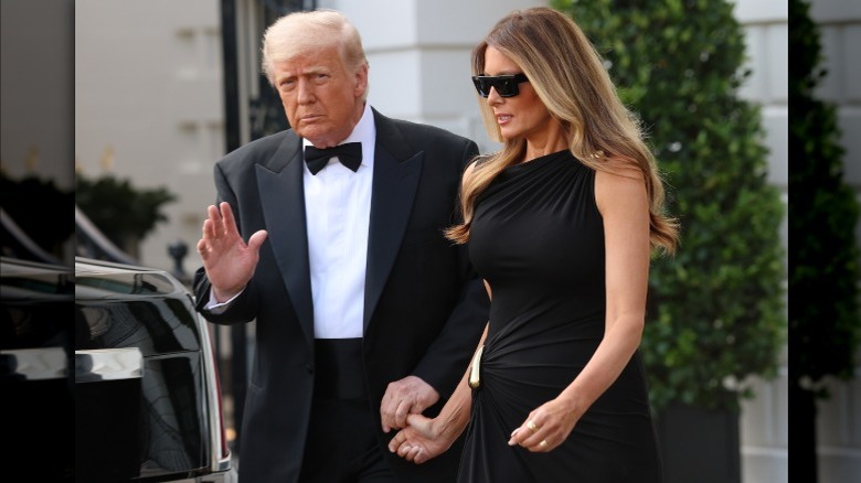 Donald Trump holding Melania Trump's thumb as they walk from the White House to their car on June 11, 2025