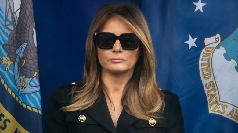 A morbid-looking Melania Trump wearing sunglasses