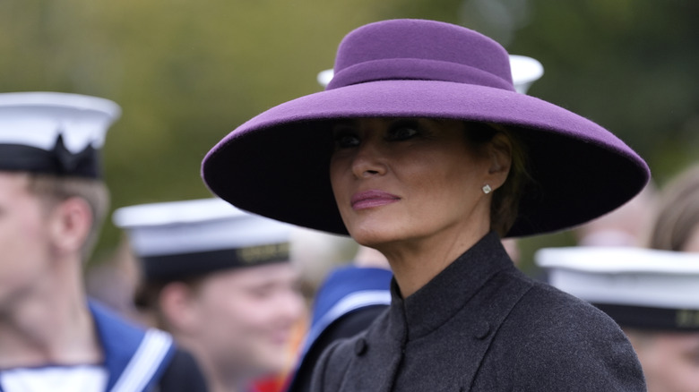 Melania Trump scowling in a big hat
