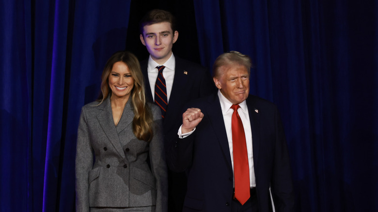 Melania, Barron, and Donald Trump stand clustered together