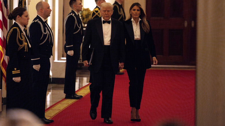 Donald Trump and Melania Trump holding hands and wearing matching tuxes at the National Governors Association Evening Dinner and Reception