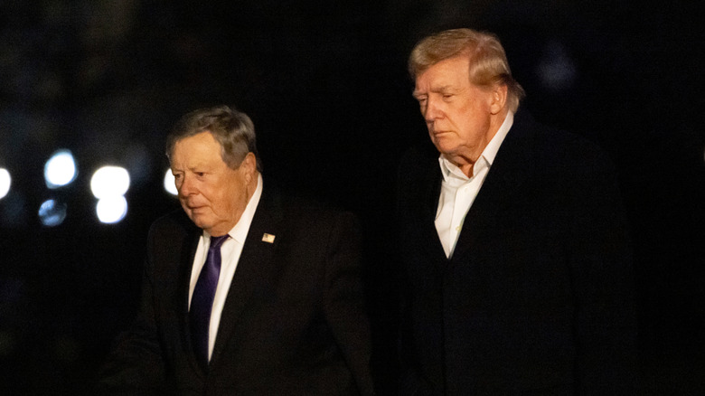 Viktor Knavs walking next to Donald Trump