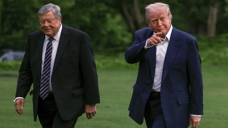 Viktor Knavs walking next to Donald Trump