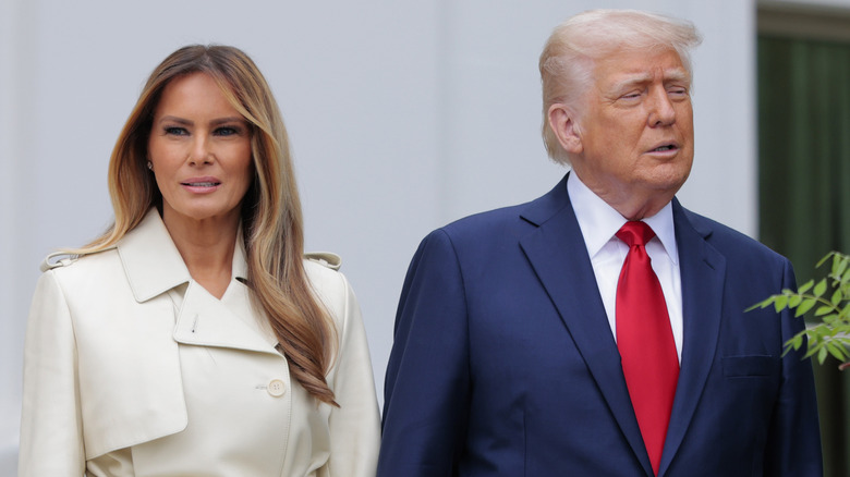 Melania Trump looking away while Donald Trump speaks