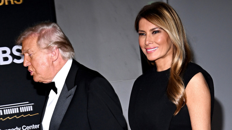 Donald Trump talking and Melania Trump smiling
