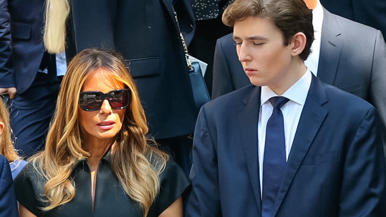 Barron Trump looks at mother Melania Trump in sunglasses