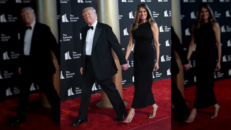 Melania and Donald Trump walking across red carpet at The Kennedy Center