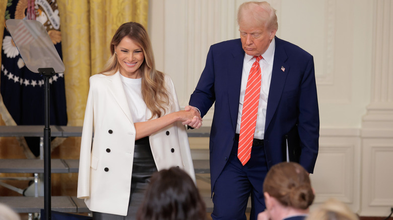 Melania and Donald Trump holding hands at the White House
