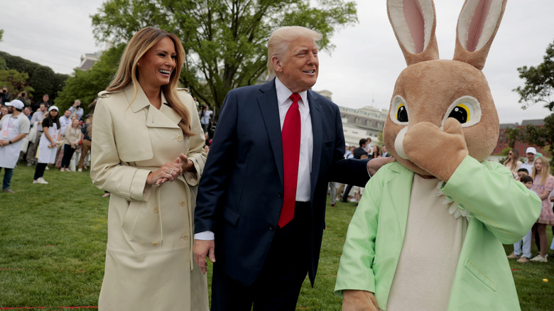 Melania and Donald Trump talking to a large bunny