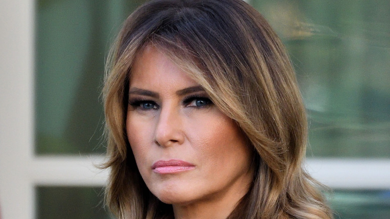 Melania Trump standing in front of American Flag in the Rose Garden