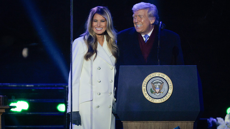 Donald Trump and Melania Trump smiling at the 2025 Tree Lighting Ceremony