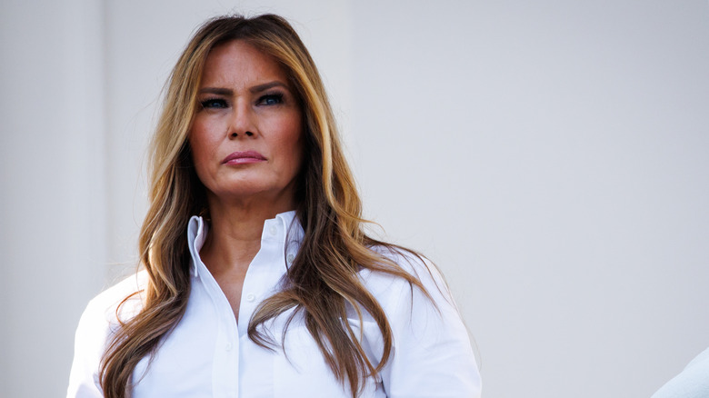 Melania Trump standing on White House balcony looking solemn