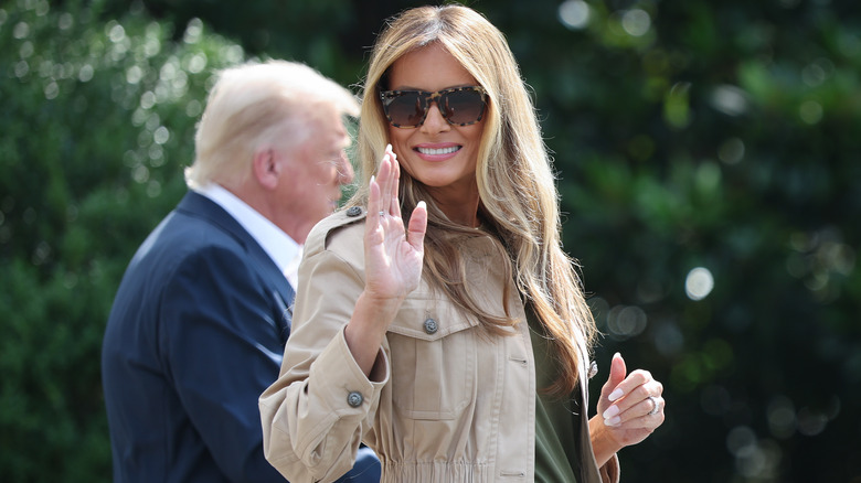 Melania Trump waving with Donald in background