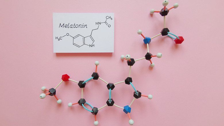 Melatonin chemical structure on a pink background
