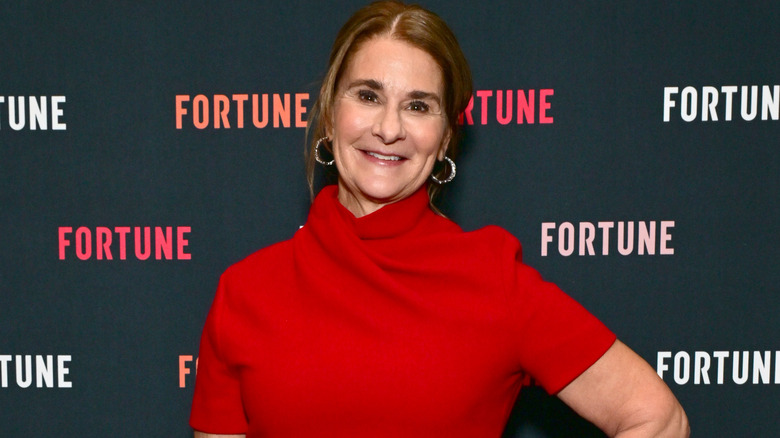Melinda French Gates smiling wearing red outfit