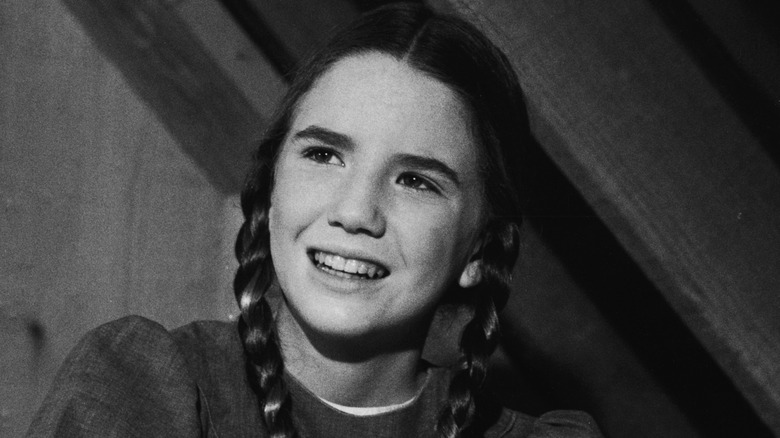 A black-and-white photo of Melissa Gilbert on the set of the original 'Little House on the Prairie'