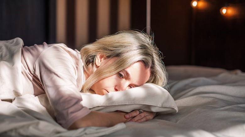 Tired woman on bed