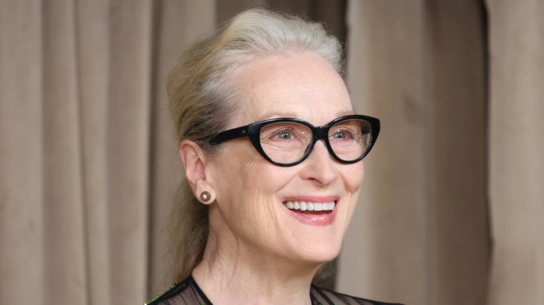 Meryl Streep wearing black glasses and smiling