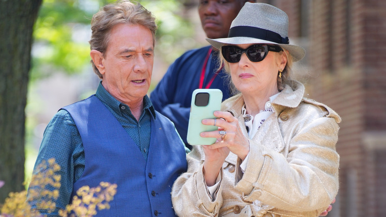 Meryl Streep showing Martin Short something on her phone on the set of "Only Murders in the Building"