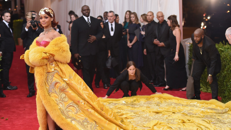 Rihanna in a yellow over the top gown