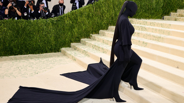 Kim Kardashian in a black outfit covering the entire body