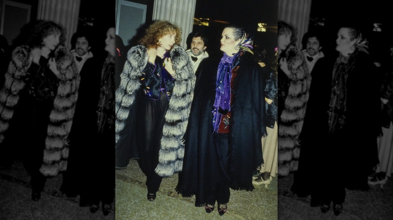 Ariane Brenner in a Givenchy coat (right) next to an unidentified woman in a grey fur coat (left) with Emanuel Ungaro at the Metropolitan Museum of Art Gala in New York City