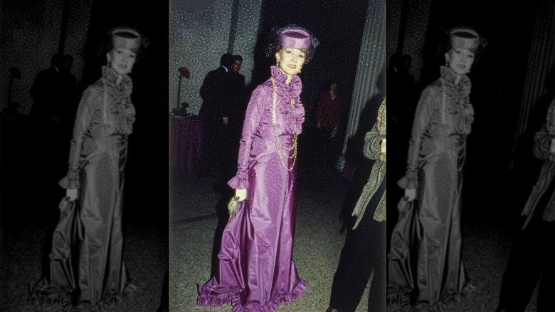 Gladys Solomon wearing a purple Adolfo gown and matching hat at the Metropolitan Museum of Art Gala in New York City
