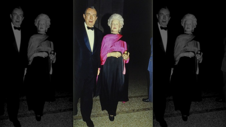 Mildred Hilson (right) wearing a black and deep pink Yves Saint Laurent gown next to unidentified man (left) at the Metropolitan Museum of Art Gala in New York City