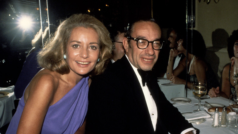 Barbara Walters and Alan Greenspan smiling in 1977 while seated at a table