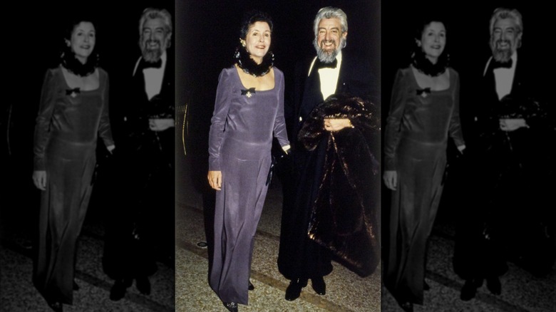 American journalist and art collector Lily Auchincloss in a purple Madame Gres gown, escorted by an unidentified man at the Met Gala
