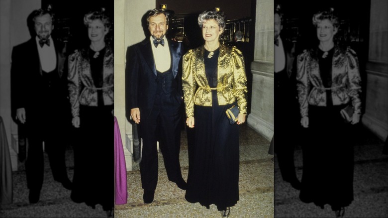 Marion Javits (right) wearing a Scott Barrie gold lamé jacket over a black dress with an unidentified man (left) at the Metropolitan Museum of Art Gala