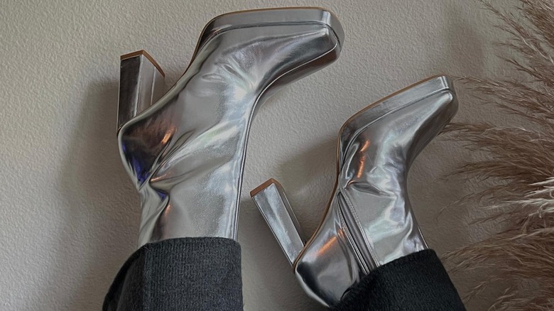 silver heeled boots against wall